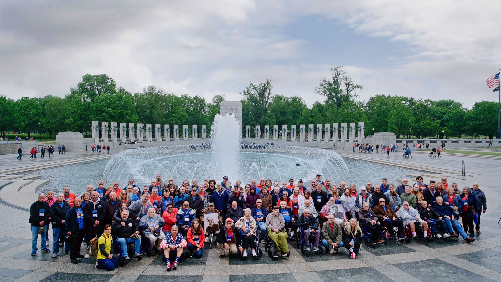 Group photo of HFLI members standing together at a memorial in Washington, D.C.